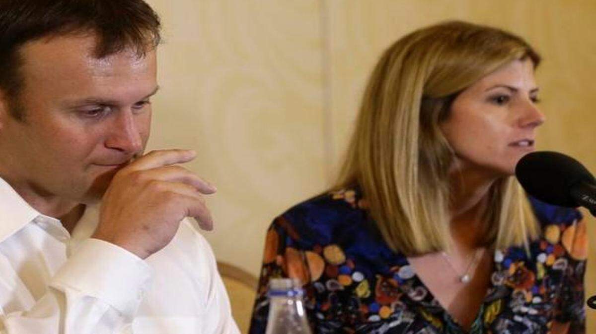 
Former Miami Dolphins fullback Rob Konrad listens while his wife Tammy speaks during a news conference where he told about his ordeal of swimming nine miles to shore after he fell off his boat while fishing off the South Florida coast, Monday, Jan. 12, 2015. 
