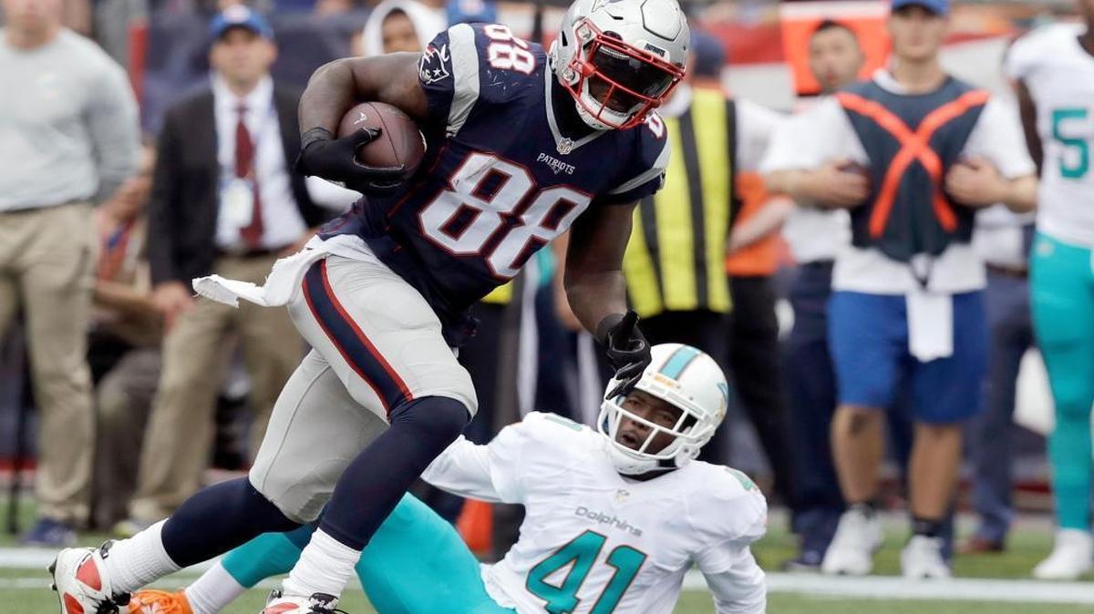 Patriots tight end Martellus Bennett (88) runs from Dolphins defensive back Byron Maxwell during Sunday’s game after delivering a stiff-arm that went viral on social media. ‘It’s going to be in the archives for the rest of my life. You’ve just got to live with it,’ Maxwell said.
