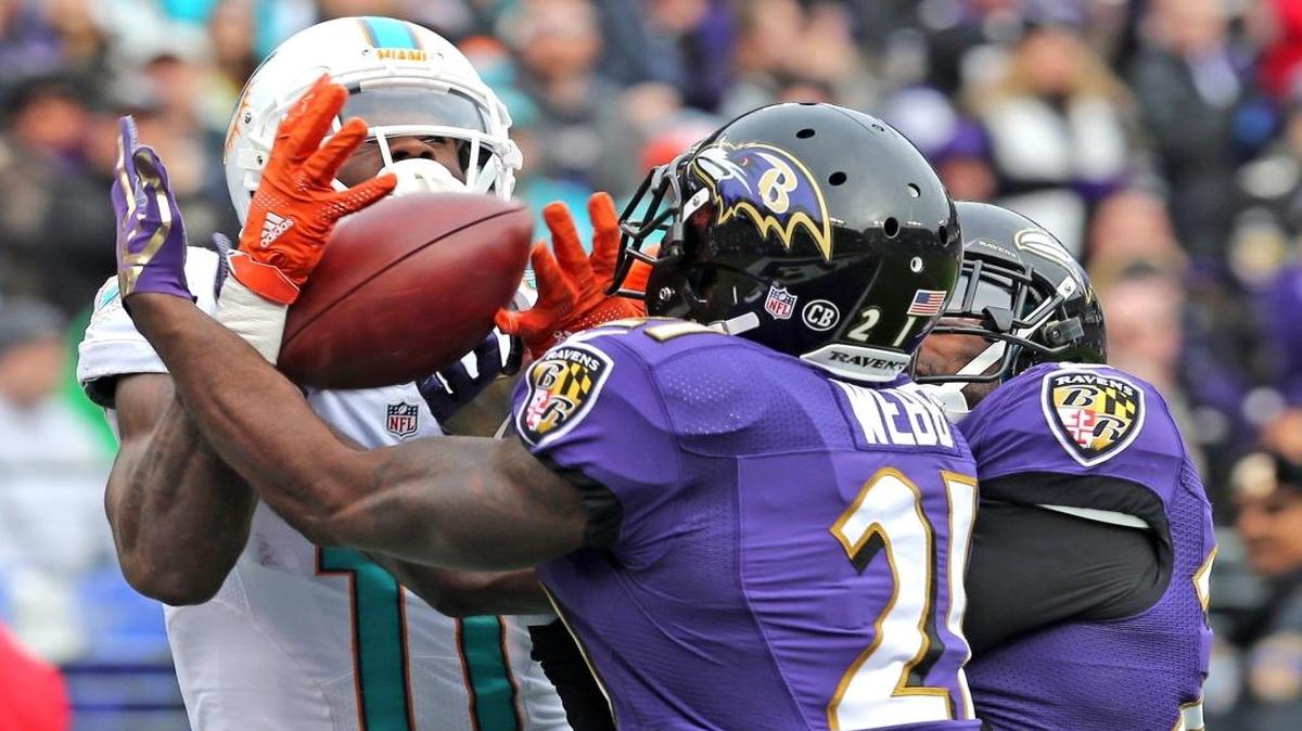 Miami Dolphins DeVante Parker can't grab the ball as Baltimore Ravens Lardarius Webb intercepts the ball in the endzone in the second quarter at M&T Bank Stadium in Baltimore, MD on Sun., Dec. 4, 2016.