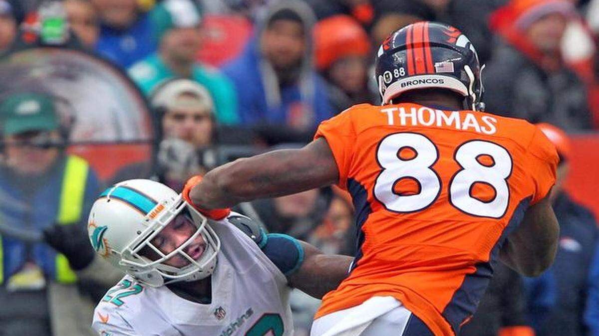 
Miami Dolphins cornerback Jamar Taylor is pushed away by Denver Broncos receiver Demaryius Thomas in the second quarter at Sports Authority Field at Mile High in Denver, Colorado, Nov. 23, 2014.
