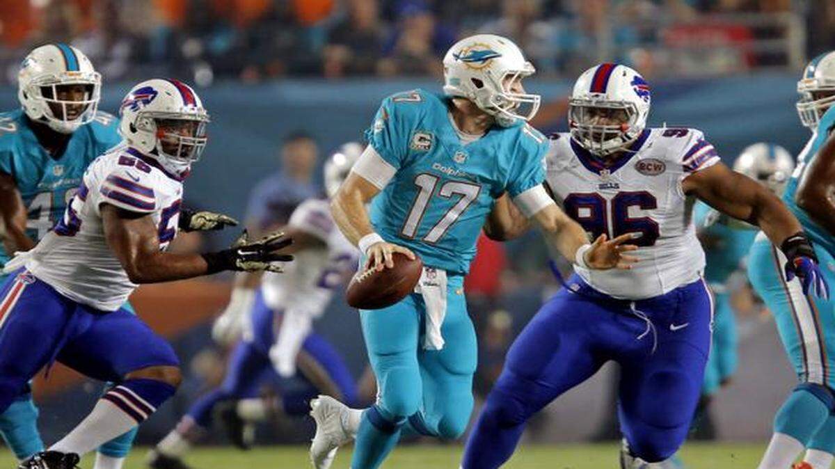 
Miami Dolphins quarterback Ryan Tannehill (17) under pressure from Buffalo Bills defensive tackle Stefan Charles (96) and defensive end Jerry Hughes (55) in the first quarter at Sun Life Stadium in Miami Gardens on Thursday, Nov. 13, 2014.
