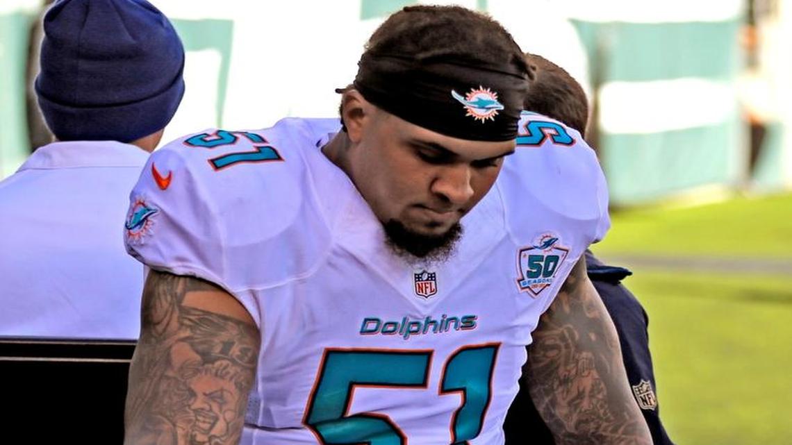 An injured Miami Dolphins center Mike Pouncey is carted off as the New York Jets host the Miami Dolphins at Met Life Stadium in East Rutherford, N.J., on Sunday, November 29, 2015.