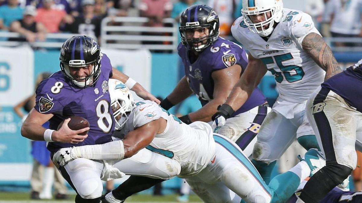 Baltimore Ravens quarterback Matt Schaub (8) is sacked by Miami Dolphins defensive end Olivier Vernon (50) in the third quarter as the Miami Dolphins host the Baltimore Ravens at Sun Life Stadium on Sunday, December 6, 2015.