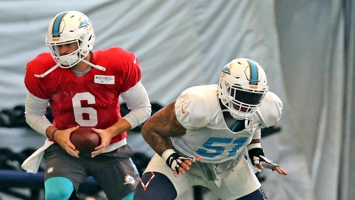 Dolphins center Mike Pouncey (51) and quarterback Jay Cutler (6) at the Miami Dolphins training facility in Davie, Fla.