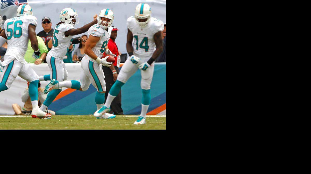 
Miami Dolphins outside linebacker Jason Trusnik (93) recovers a blocked punt in the first quarter against the New England Patriots at Sun Life Stadium in Miami Gardens on Sunday, Sept. 7, 2014.
