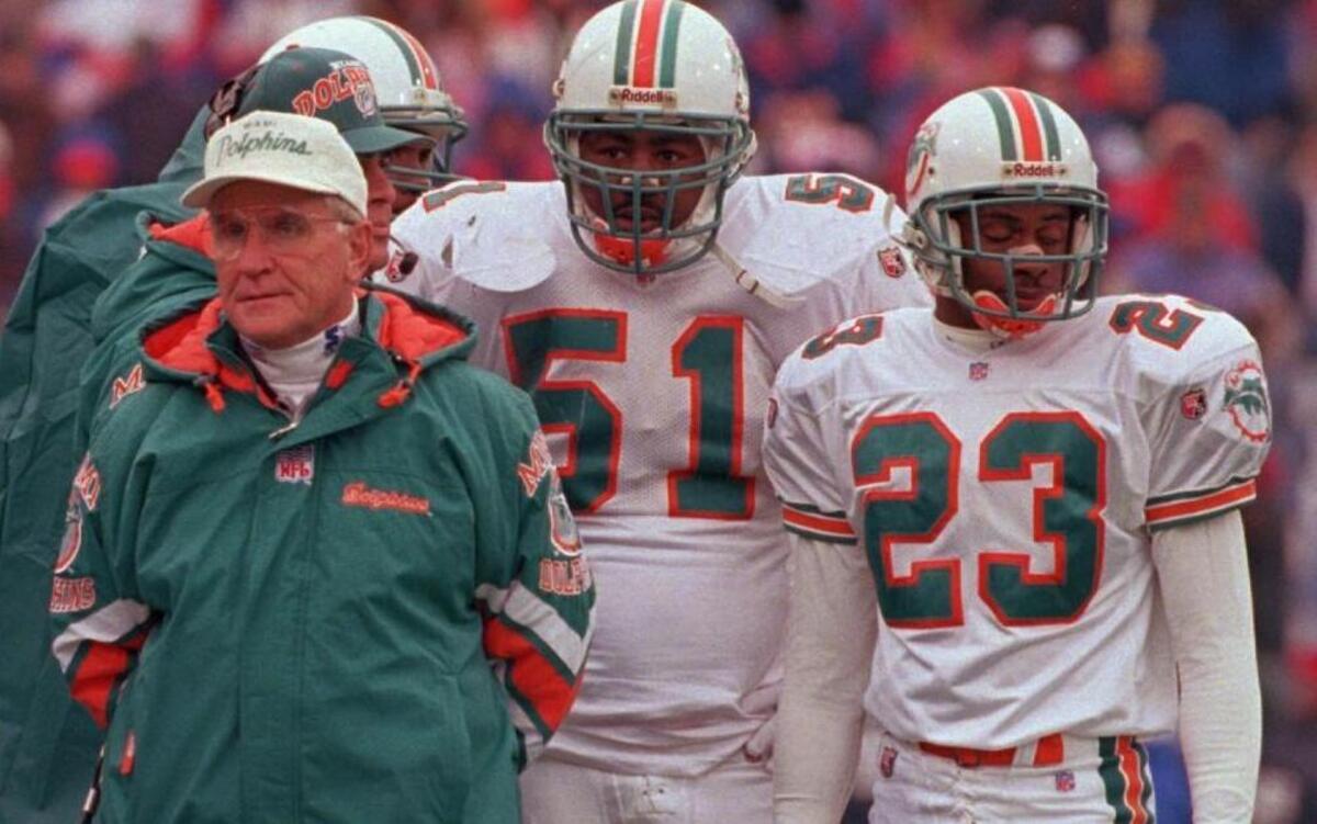 Miami Dolphins head coach Don Shula, left, linebacker Bryan Cox (51) and cornerback Troy Vincent (23) watch the Buffalo Bills defense in action during the fourth quarter of the Bills 37-22 AFC playoff victory Sat., Dec. 30, 1995, at Rich Stadium in Orchard Park, N.Y.