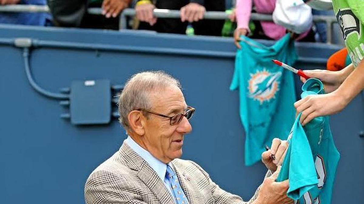Miami Dolphins owner Stephen Ross signs an autograph for Isaac Taz as the Fins prepare to play the Seattle Seahawks at CenturyLink Field in Seattle, September 11, 2016.