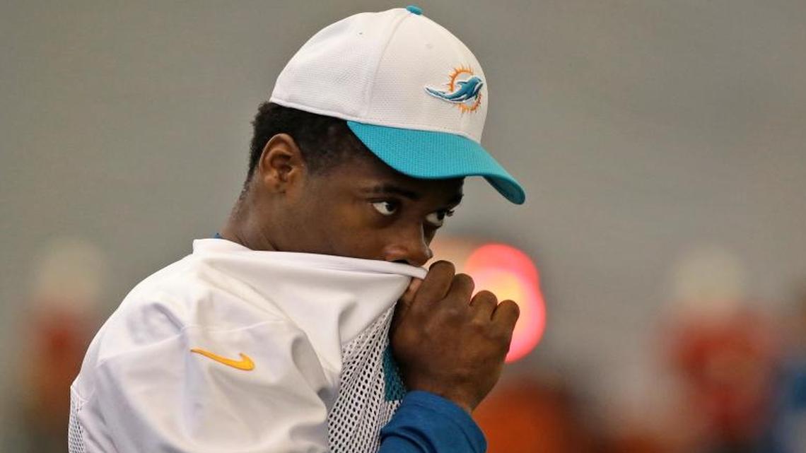 
Miami Dolphins wide receiver DeVante Parker wipes his face as he looks on at the teams NFL football training camp, Tuesday, Aug. 4, 2015 in Davie, Fla.
