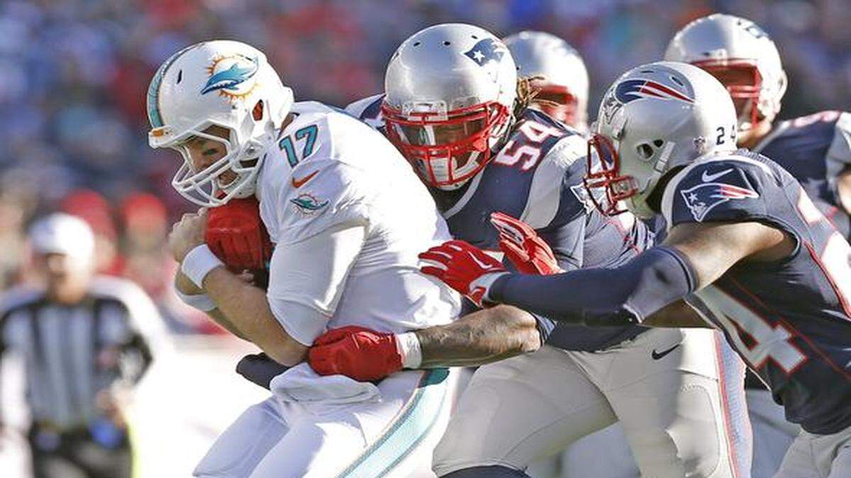 
Miami Dolphins quarterback Ryan Tannehill (17) is chased by the Patriots in the first quarter as the New England Patriots host the Miami Dolphins at Gillette Stadium on Sunday, Dec. 14, 2014
