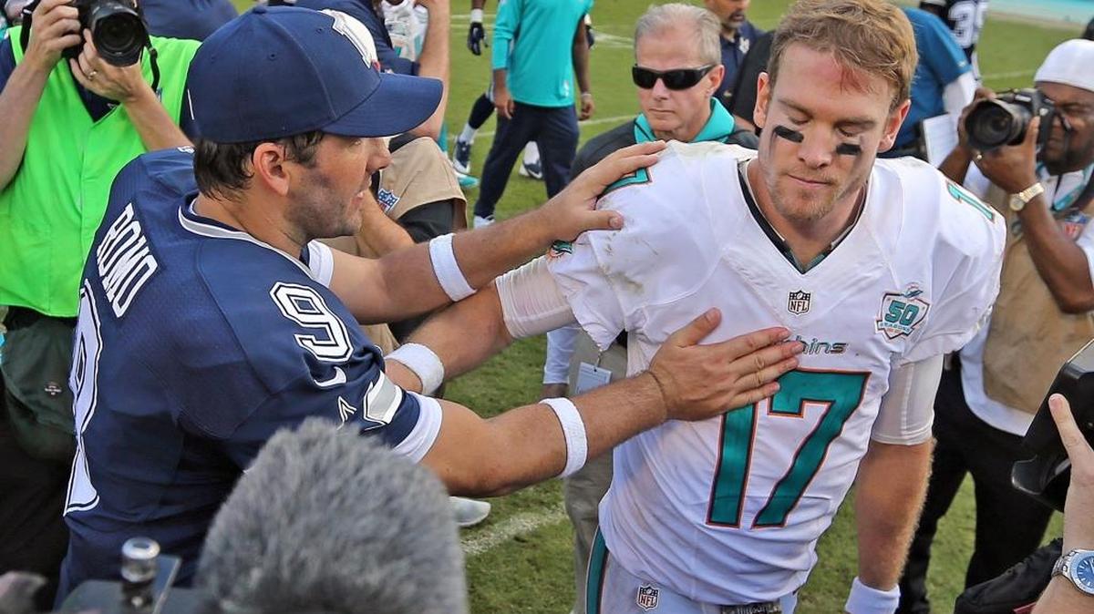 Miami Dolphins quarterback Ryan Tannehill and Dallas quarterback Tony Romo meet at midfield following the Cowboys’ 24-14 win at Sun Life Stadium last season.