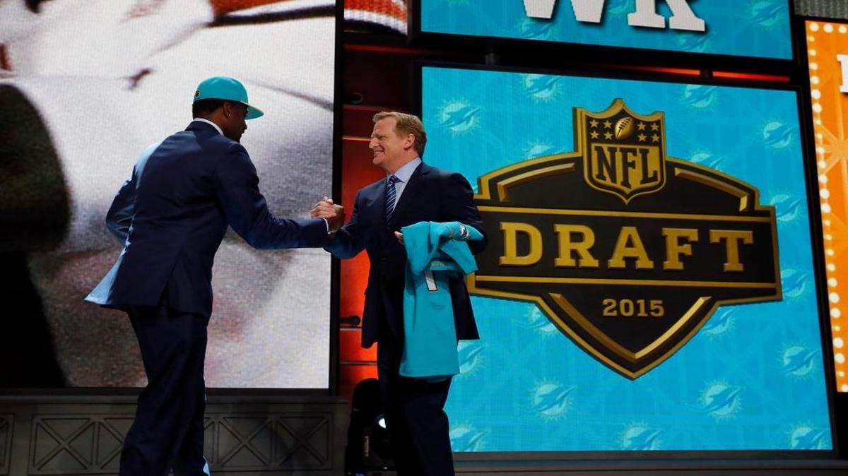 DeVante Parker celebrates with NFL Commissioner Roger Goodell after being selected by the Miami Dolphins as the 14th pick in the first round of the 2015 NFL Draft.