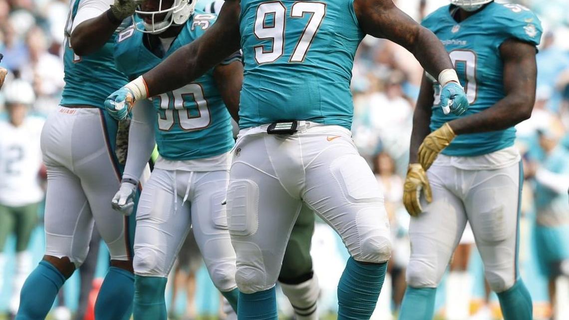 Miami Dolphins defensive tackle Jordan Phillips (97) and teammates react after a defensive play in the first quarter as the Miami Dolphins host the New York Jets at Hard Rock Stadium on Sunday, November 6, 2016.
