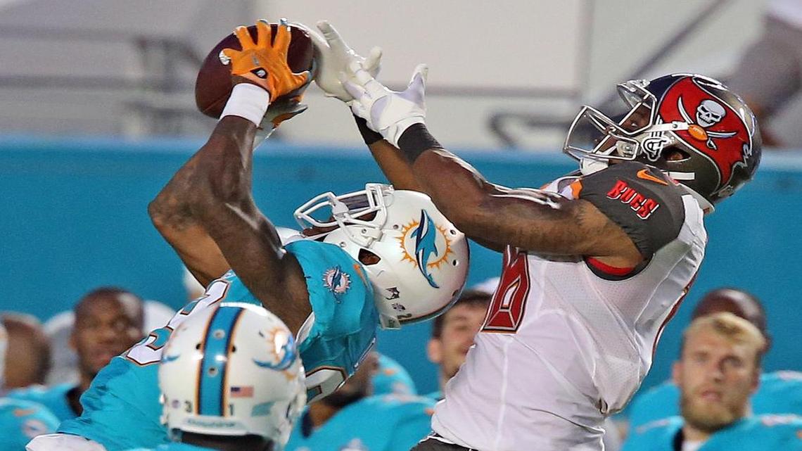 
Miami Dolphins’ Will Davis intercepts the ball from Tampa Bay Buccaneers’ Rannell Hall in the first quarter at Sun Life Stadium in Miami Gardens on September 3, 2015.
