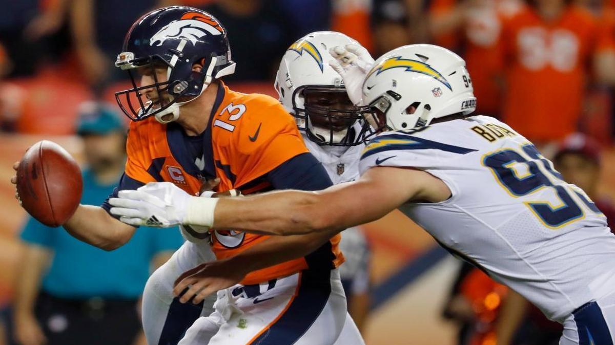 Denver Broncos quarterback Trevor Siemian is hit by Los Angeles Chargers defensive end Joey Bosa in Week 1.