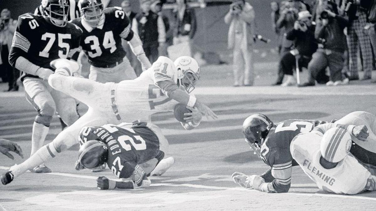 Jim Kiick of the Miami Dolphins goes head first over Glen Edwards of the Pittsburgh Steelers as he scores in the third quarter of their AFC championship game at Three Rivers Stadium in Pittsburgh, Pa., Dec. 31, 1972. The Dolphins won 21-17. Nick Buoniconti and Kiick, two prominent members of the 1972 undefeated team, now are dealing with progressively diminished cognitive skills, a potential warning sign of a degenerative brain disease, CTE, that has been strongly linked to football head injuries.