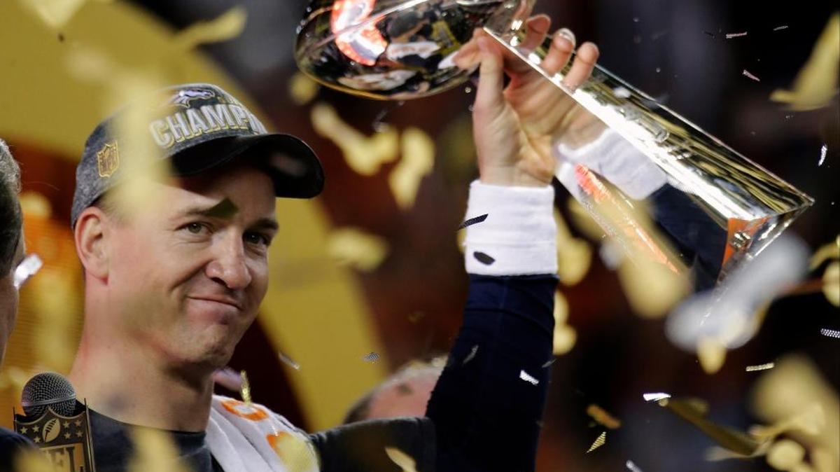 Denver Broncos’ Peyton Manning holds up the trophy after the NFL Super Bowl 50 football game in Santa Clara, Calif.