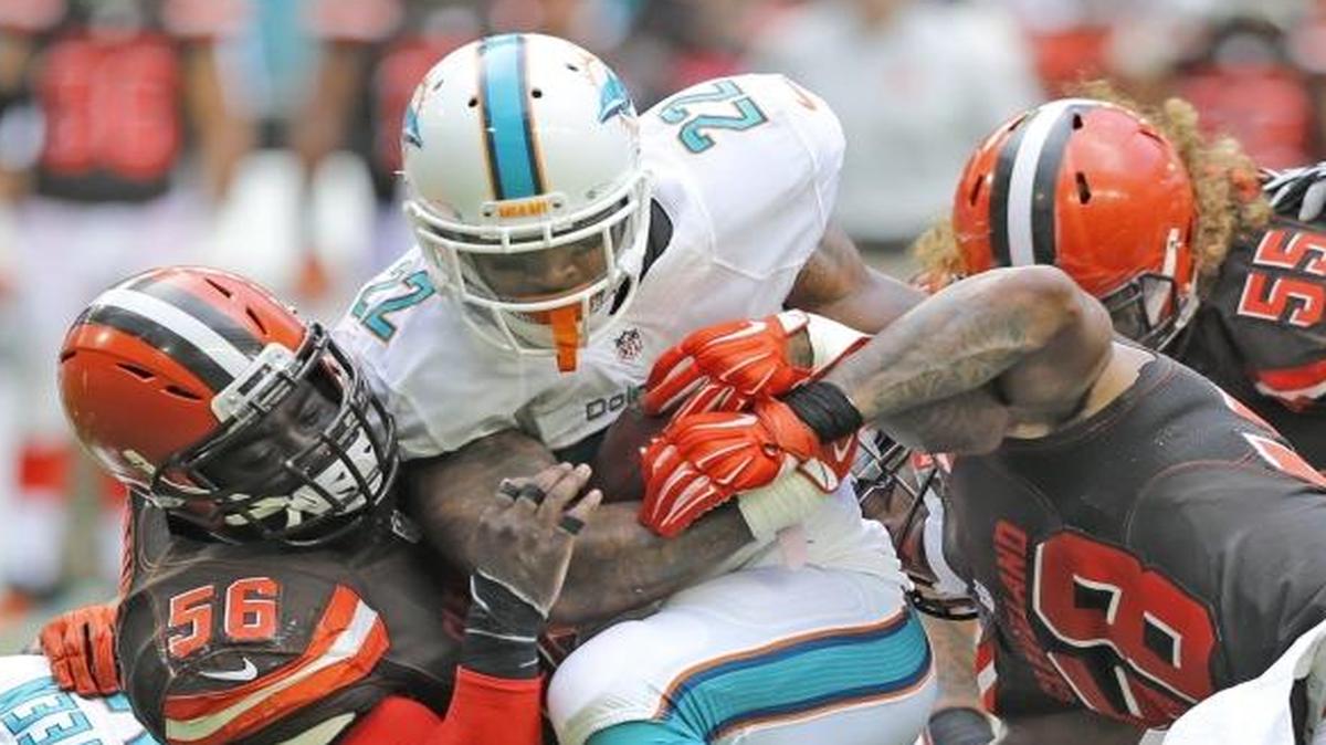 Isaiah Pead is taken down by Cleveland inside linebacker Demario Davis in the second quarter of the Dolphins win against the Browns on Sept. 25.