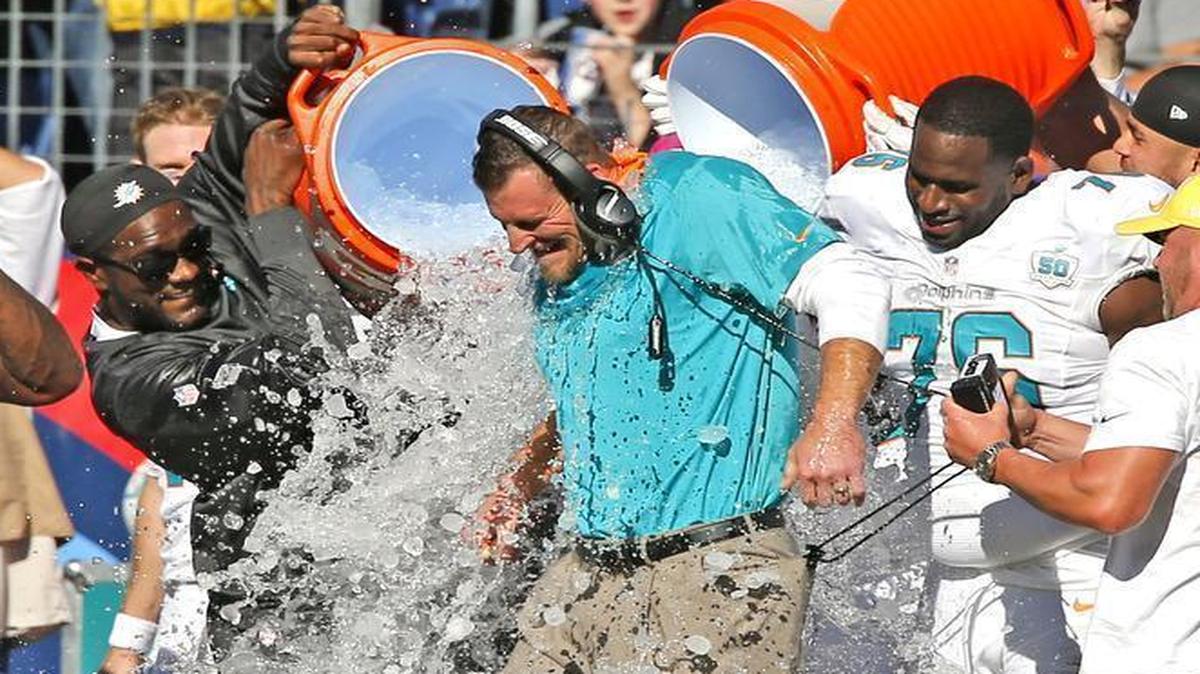 
Miami Dolphins interim coach Dan Campbell is drenched as he wins his first NFL game 38-10 against the Tennessee Titans at Nissan Stadium in Nashville, Tenn., Sunday, Oct. 18, 2015.
