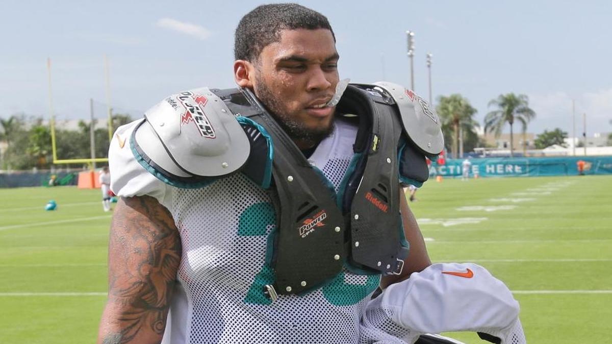 
Miami Dolphins guard Jamil Douglas walks off the field after a training camp practice Wednesday, Aug. 5, 2015 in Davie, Fla. 
