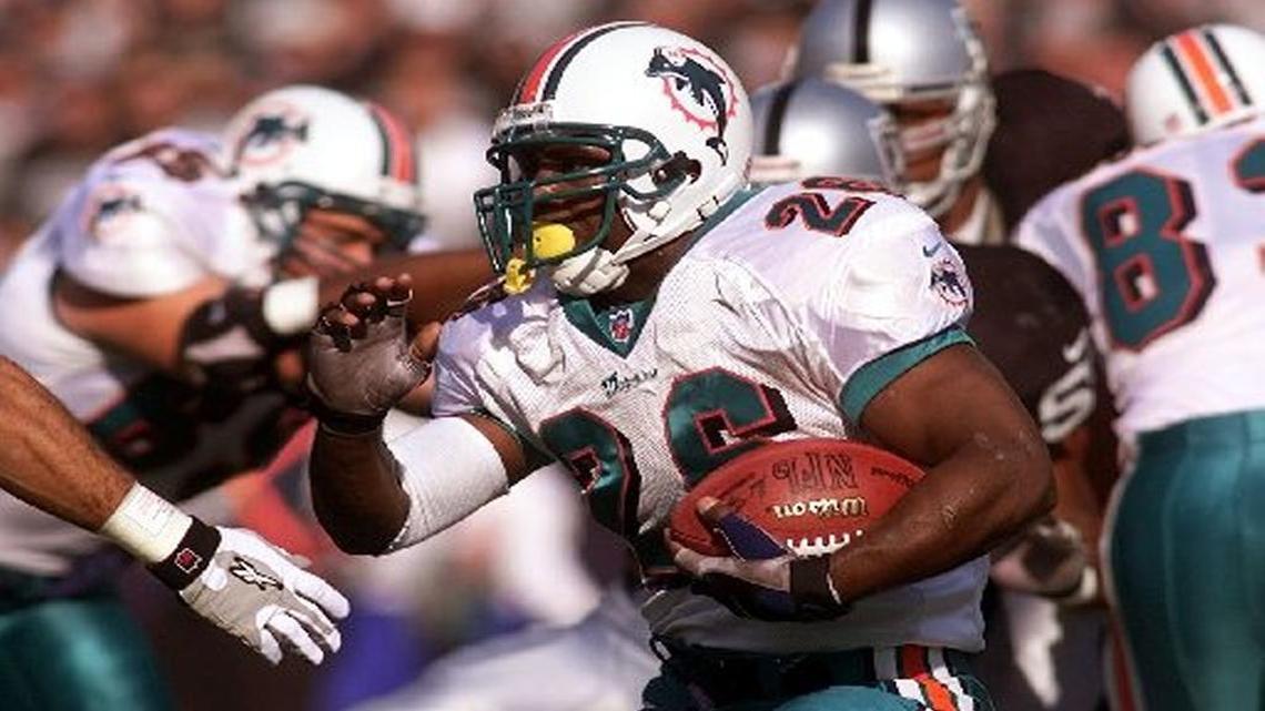 Miami running back Lamar Smith runs the ball against the Oakland Raiders on Jan. 6, 2001.