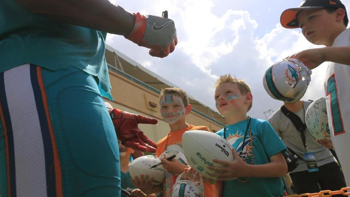 Fans wait in line for autographs during the first day of Miami Dolphins training camp.