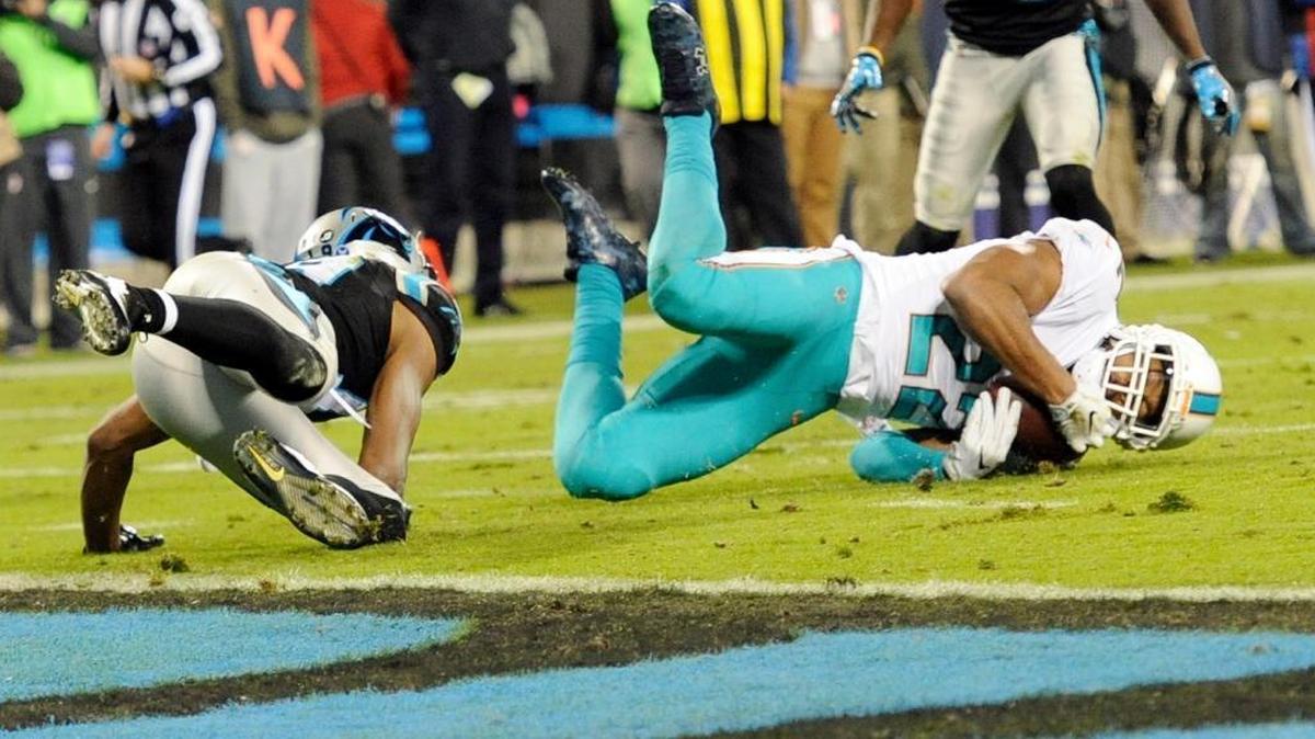 Miami Dolphins safety T.J. McDonald (22) tries to intercept a pass intended for Carolina Panthers’ Russell Shepard (19) in the first half of a game last November. McDonald raised his play during the offseason program and training camp and will remain a starter.