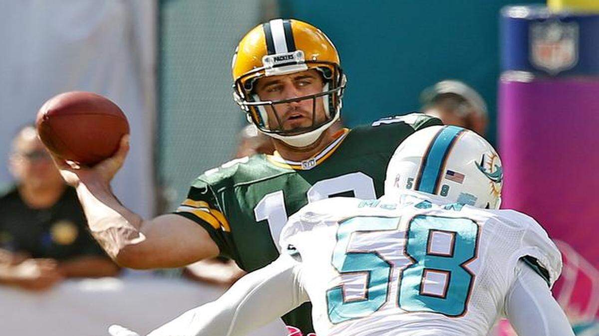 
Miami Dolphins linebacker Chris McCain chases Green Bay Packers quarterback Aaron Rodgers in the third quarter at Sun Life Stadium in Miami Gardens on Oct. 12, 2014.
