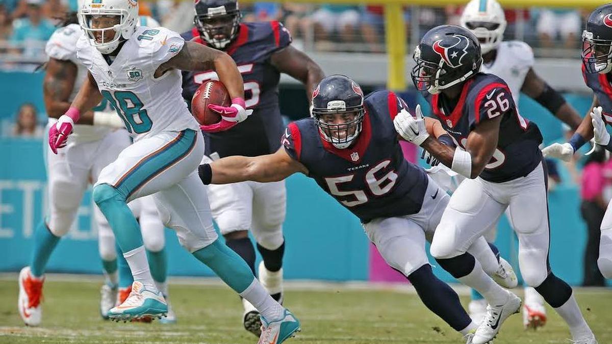 Miami Dolphins Rishard Matthews breaks the tackle attempt of Houston Texans Brian Cushing and runs for a first quarter touchdown at Sun Life Stadium in Miami Gardens, Florida, October 25, 2015.