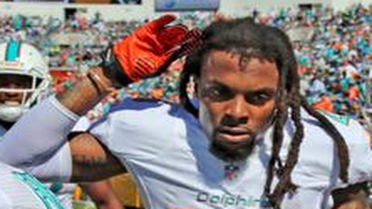 
Miami Dolphins safety Louis Delmas (25) celebrates after returning an interception 81 yards for a touchdown against the Jacksonville Jaguars on Sunday, Oct. 26, 2014.
