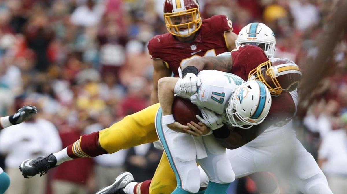 
Miami Dolphins quarterback Ryan Tannehill (17) is sacked by Washington Redskins defensive end Jason Hatcher (97) in the second quarter. The Washington Redskins hosted the Miami Dolphins at FedExField in Landover, Maryland on Sunday, September 13, 2015.

