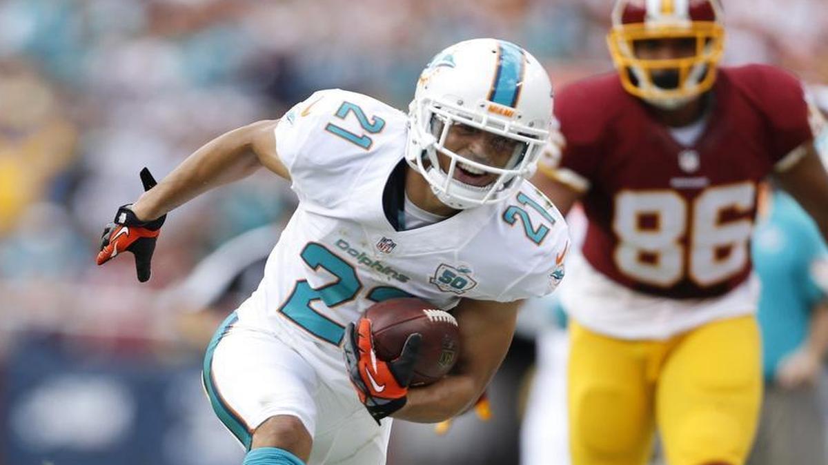 
Miami Dolphins cornerback Brent Grimes (21) makes an interception against the Washington Redskins at FedExField in Landover, Maryland on Sunday, September 13, 2015.
