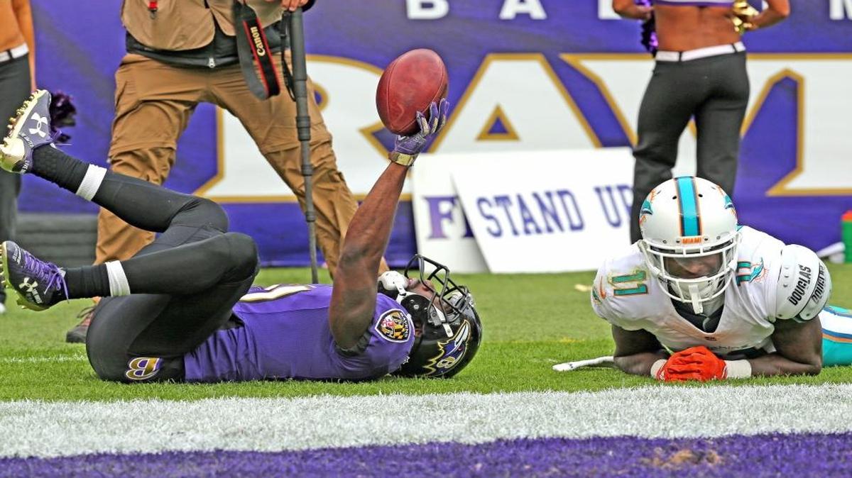 DeVante Parker, right, somehow let Lardarius Webb rip a would-be touchdown from his grasp.