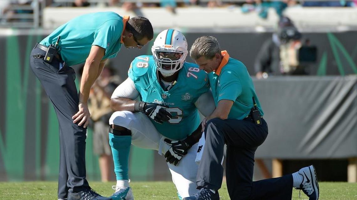 
Miami Dolphins left tackle Branden Albert is helped by trainers during the first half against the host Jacksonville Jaguars on Sunday, Sept. 20, 2015. Albert missed Sunday’s game against Buffalo.

