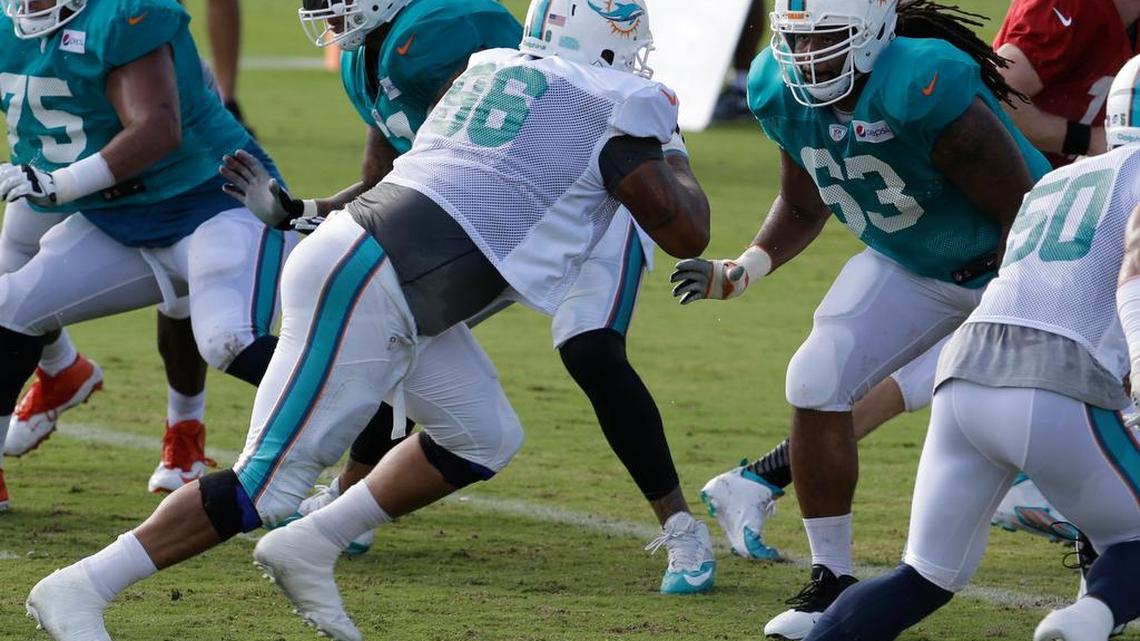 
Miami Dolphins guard Dallas Thomas (63) goes up against defensive tackle A.J. Francis (96) during a training camp practice Sunday, Aug. 16, 2015 in Davie.
