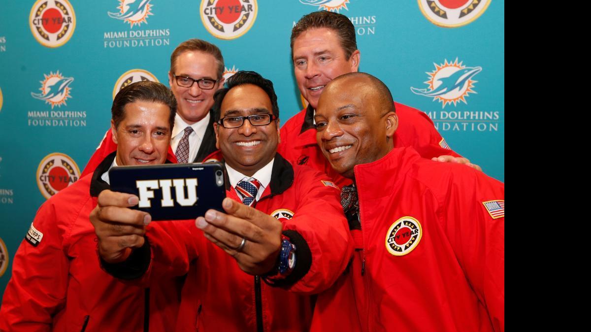 
FIU's Vice President for Engagement Saif Ishoof takes a selfie with from left: Schools Superintendent Alberto Carvallho; Dolphin's President and CEO Tom Garfinkel; Dan Marino; and Miami Gardens Mayor Oliver Gilbert. Miami Dolphins Announce $1 Million Partnership with City Year Miami on Tuesday, April 28, 2015 at Norland High School in Miami Gardens. Through the educational pillar of their foundation, the Dolphins partner with public schools to help students through graduation. City Year is an education-focused organization that partners with high need public schools across the country. Teams of 17 to 24 year old members are there to support students by focusing on attendance, behavior and course performance through in-class support, tutoring, mentoring and after school programs.
