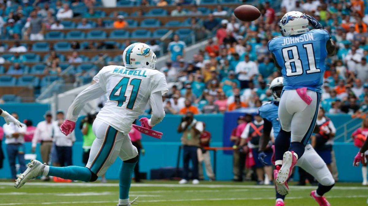 Tennessee Titans wide receiver Andre Johnson (81) catches a pass for a touchdown as Miami Dolphins cornerback Byron Maxwell (41) is late with the tackle, during the first half of Sunday’s game at Hard Rock Stadium.