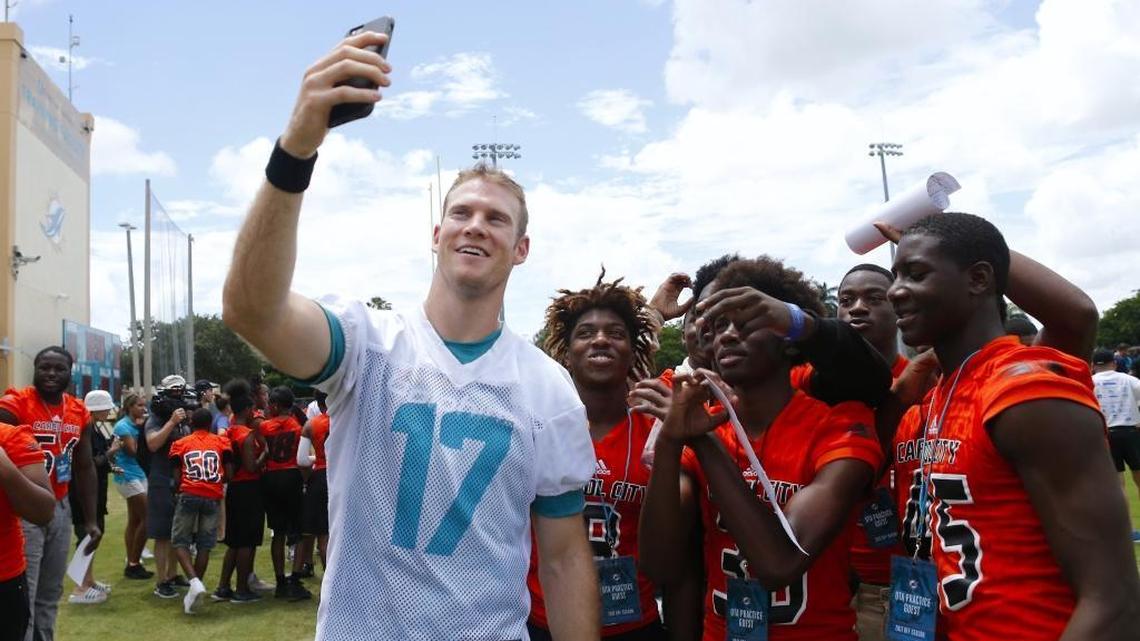 Ryan Tannehill, a three-star recruit from Texas, poses for pictures with Carol City football players last spring.