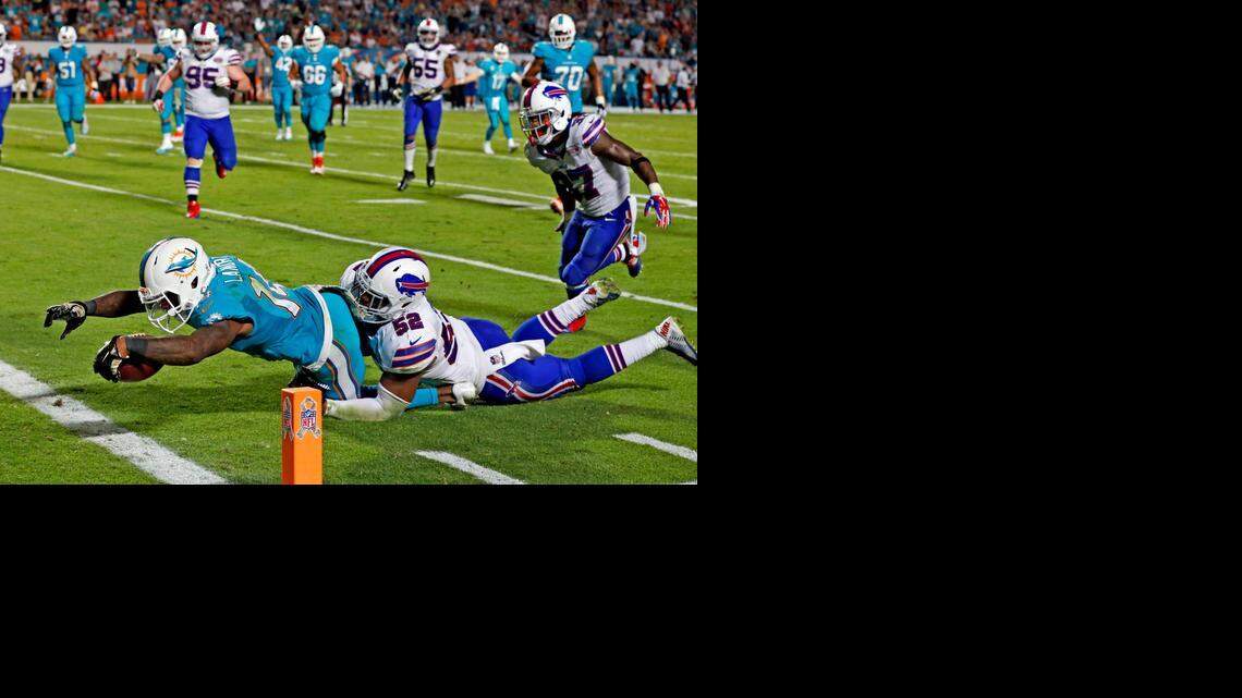 
Miami Dolphins wide receiver Jarvis Landry scores a fourth-quarter touchdown as Buffalo Bills defender Preston Peterson fails to defend at Sun Life Stadium in Miami Gardens on Thursday, Nov. 13, 2014.
