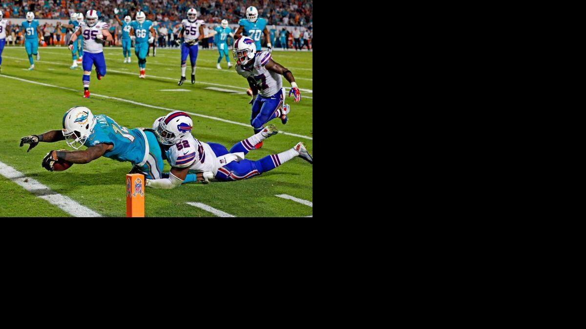 
Miami Dolphins wide receiver Jarvis Landry scores a fourth-quarter touchdown as Buffalo Bills defender Preston Peterson fails to defend at Sun Life Stadium in Miami Gardens on Thursday, Nov. 13, 2014.
