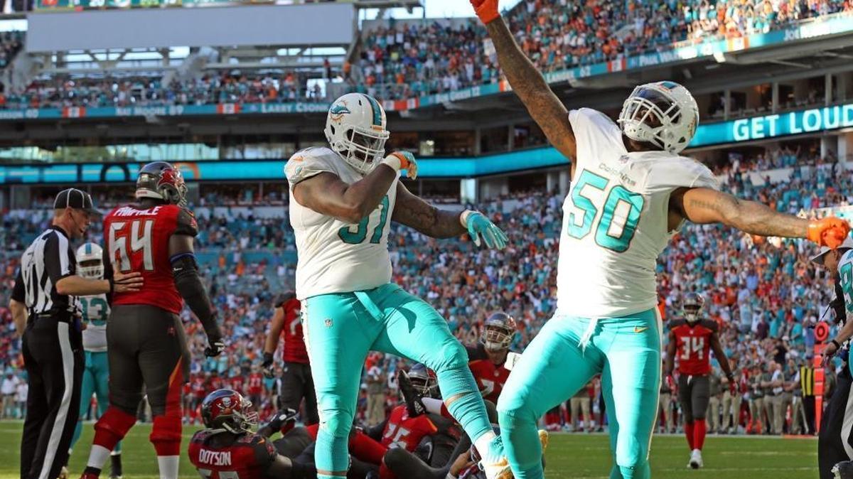 Miami Dolphins Jordan Philips (97) and Andre Branch celebrate after they thought they sacked Tampa Bay Buccaneers quarterback Ryan Fitzpatrick in the end zone for a safety.