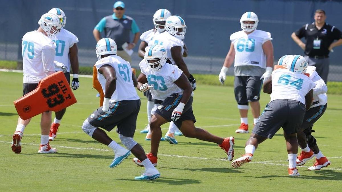 Dolphins offensive guards Laremy Tunsil (67) and Dallas Thomas (63) face off during drills at Dolphins minicamp on Tuesday.