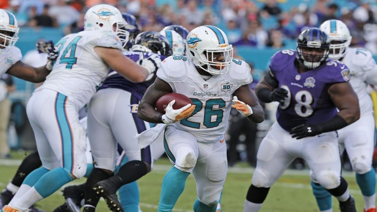 Miami Dolphins running back Lamar Miller (26) on a carry in the second half as the Miami Dolphins host the Baltimore Ravens at Sun Life Stadium on Sunday, December 6, 2015.