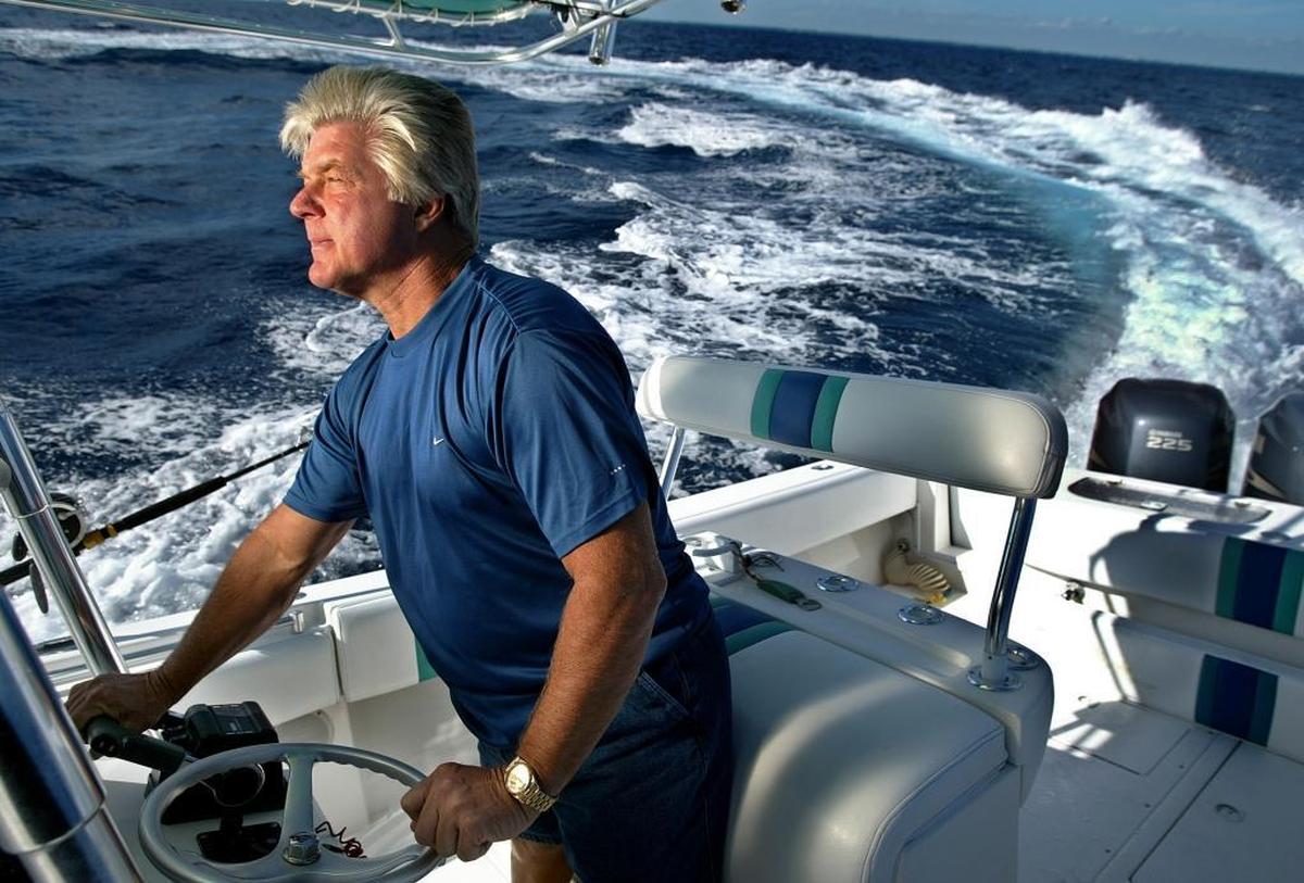 Former Miami Dolphins and University of Miami coach Jimmy Johnson skippers his fishing boat JJ's off Islamorada Key in 2002.