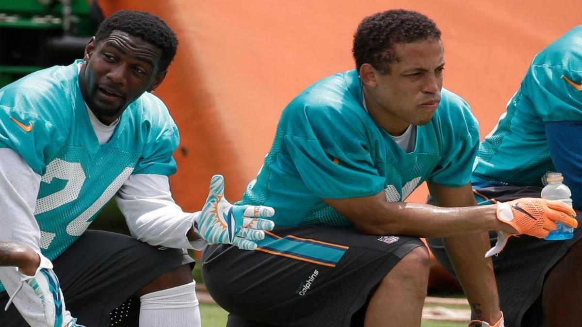
Miami Dolphins cornerbacks Brice McCain, left, and Brent Grimes take a break from drills during an organized team activity Monday, June 8, 2015, in Davie, Fla. 
