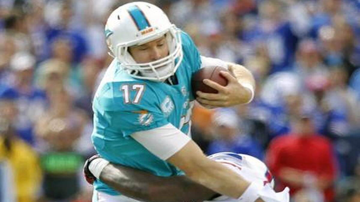 
Miami Dolphins quarterback Ryan Tannehill is sacked by Buffalo Bills strong safety Da'Norris Searcy at Ralph Wilson Stadium on Sunday, Sept. 14, 2014.
