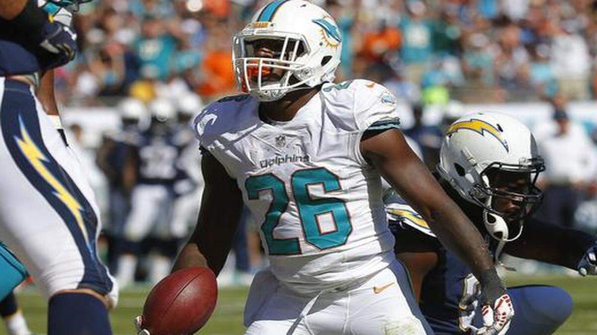 
Running back Lamar Miller of the Miami Dolphins reacts after his second-quarter touchdown against San Diego at Sun Life Stadium on Nov. 2, 2014. 
