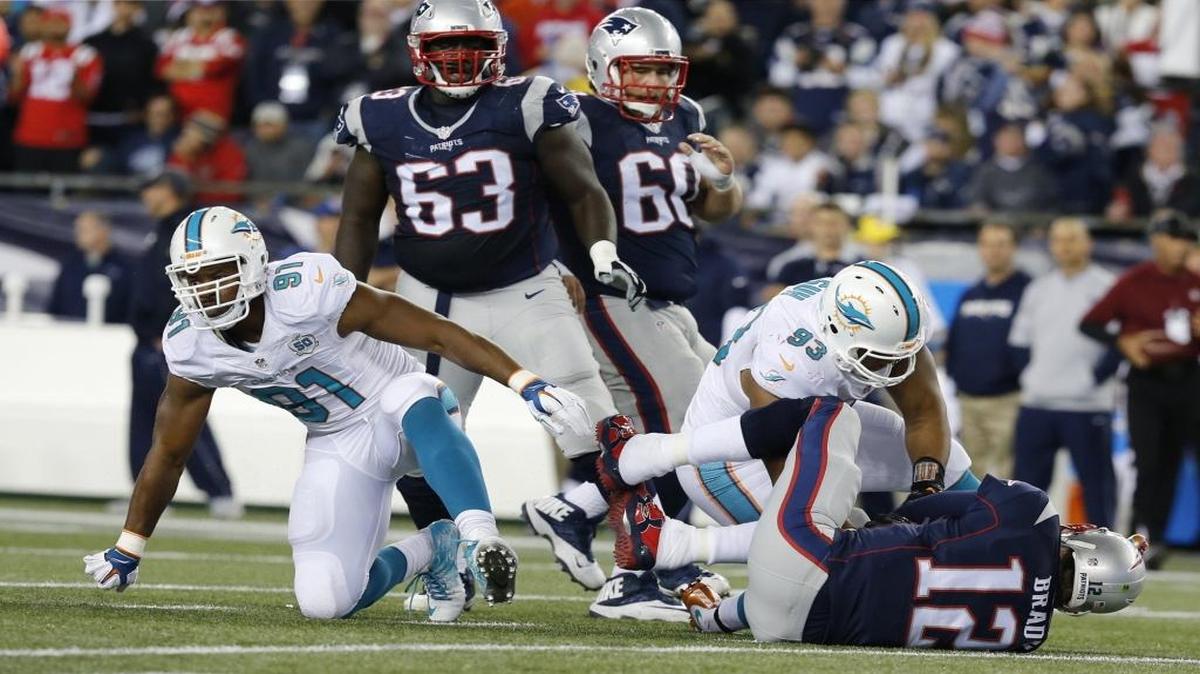 Miami Dolphins defensive end Cameron Wake (91) and defensive tackle Ndamukong Suh (93) react after New England Patriots quarterback Tom Brady is sacked in the second quarter in Gillette Stadium in Foxborough, Massachusetts on Thursday, October 29, 2015.