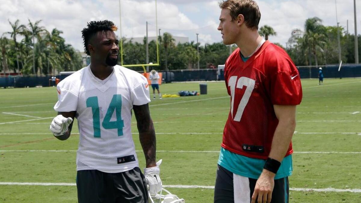 Miami Dolphins wide receiver Jarvis Landry, left, and quarterback Ryan Tannehill chat during an Organized Team Activities practice in 2015.