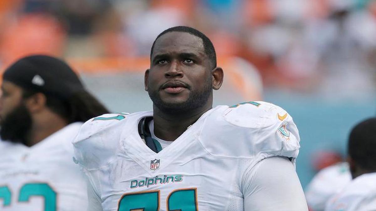 
Miami Dolphins tackle Branden Albert (71) looks up from the sideline during the second half of an NFL football game against the New England Patriots at Sun Life Stadium in Miami Gardens on Sept. 7, 2014. The Dolphins defeated the Patriots 33-20.
