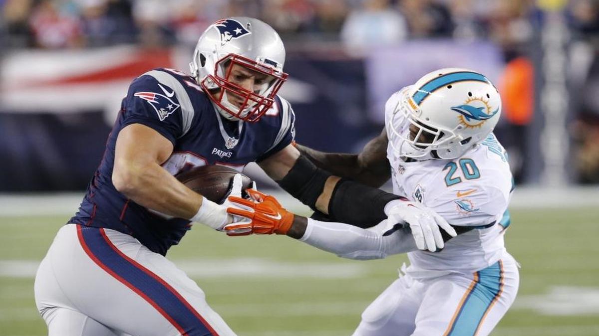 New England Patriots tight end Rob Gronkowski gets a first down as Miami Dolphins safety Reshad Jones defends in the second quarter as the at Gillette Stadium in Foxborough, Massachusetts on Thursday, October 29, 2015.